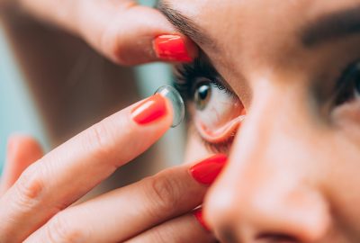 Ophthalmologist inserting soft contact lens